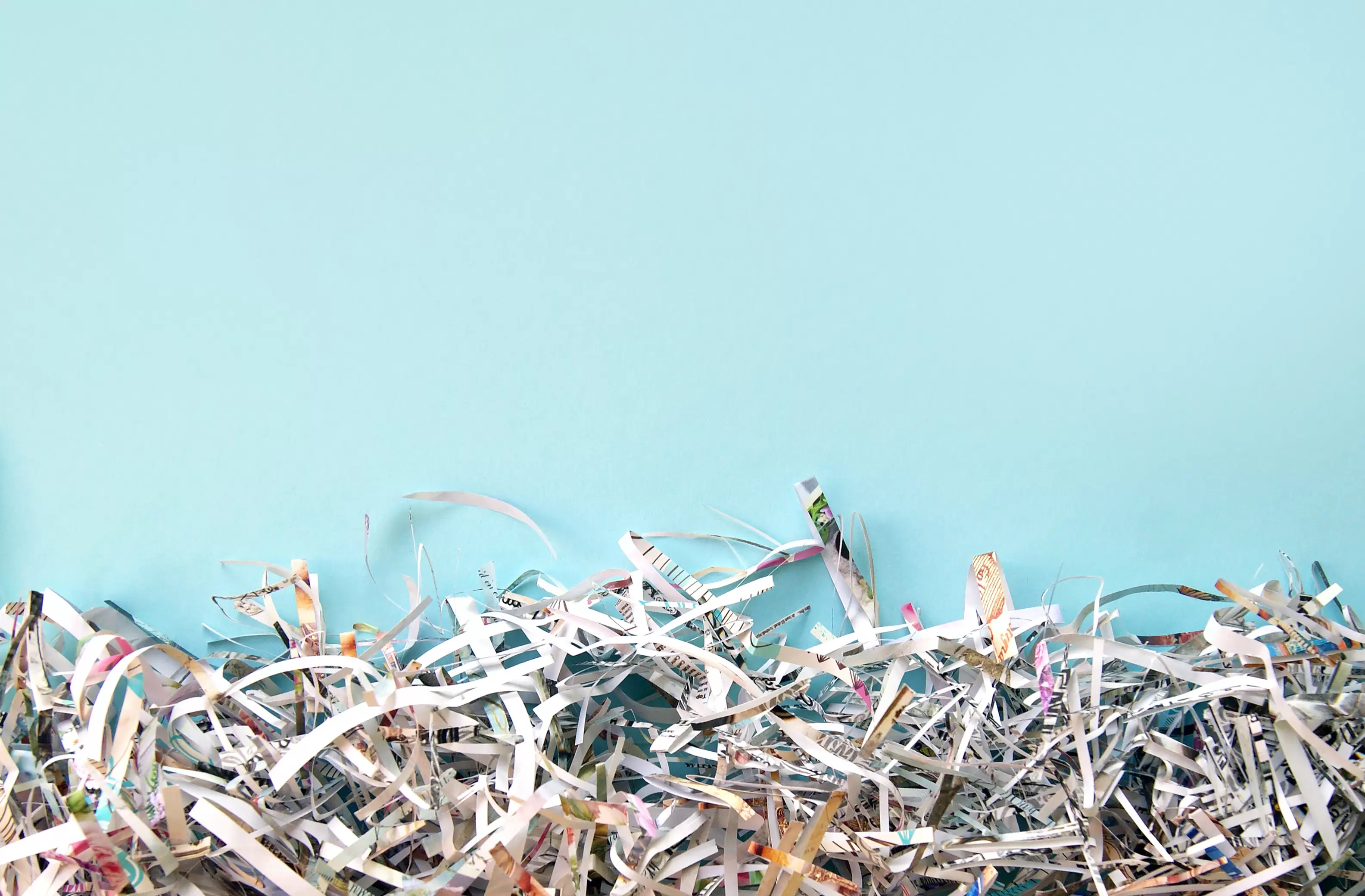 Blue background with shredded documents.